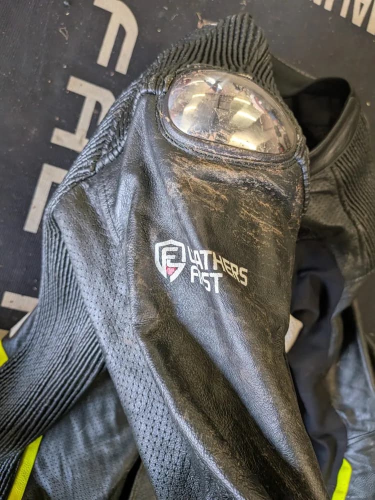 Leathers First suit shoulder slider scuffed after a 100 mph crash, leather intact